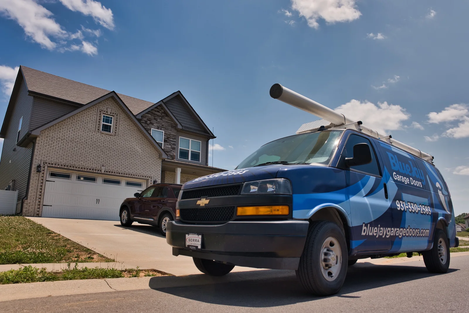 Front of a Blue Jay service van parked on a residential street