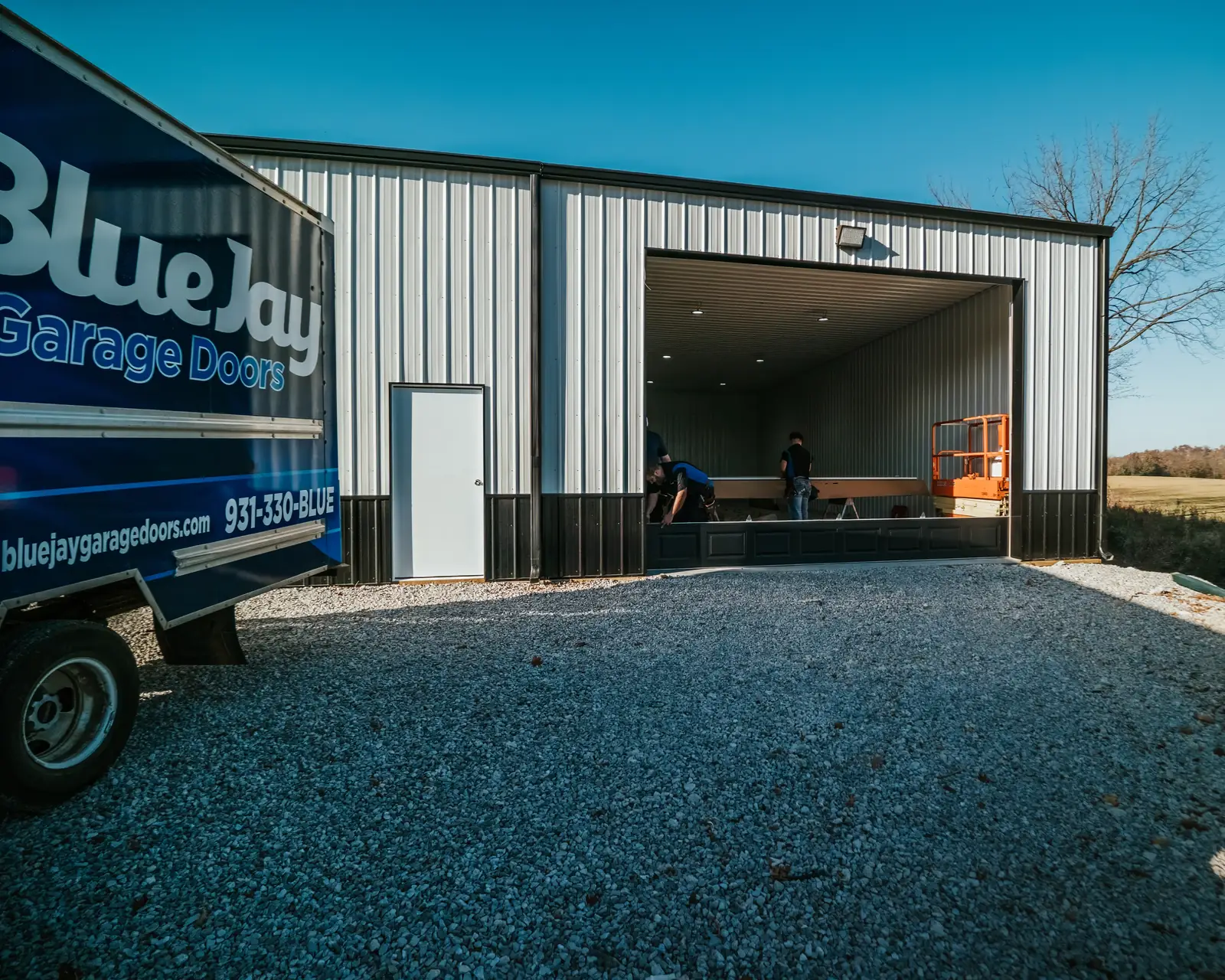 Blue Jay vehicle beside an open garage during an installation