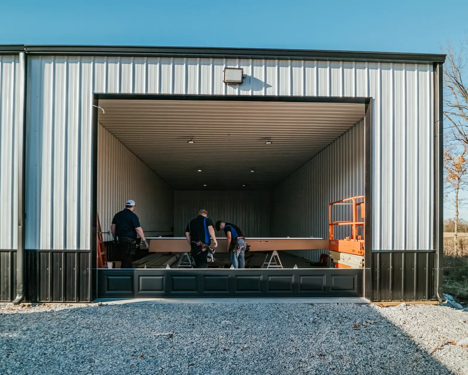 Garage door sections being assembled in a large garage opening