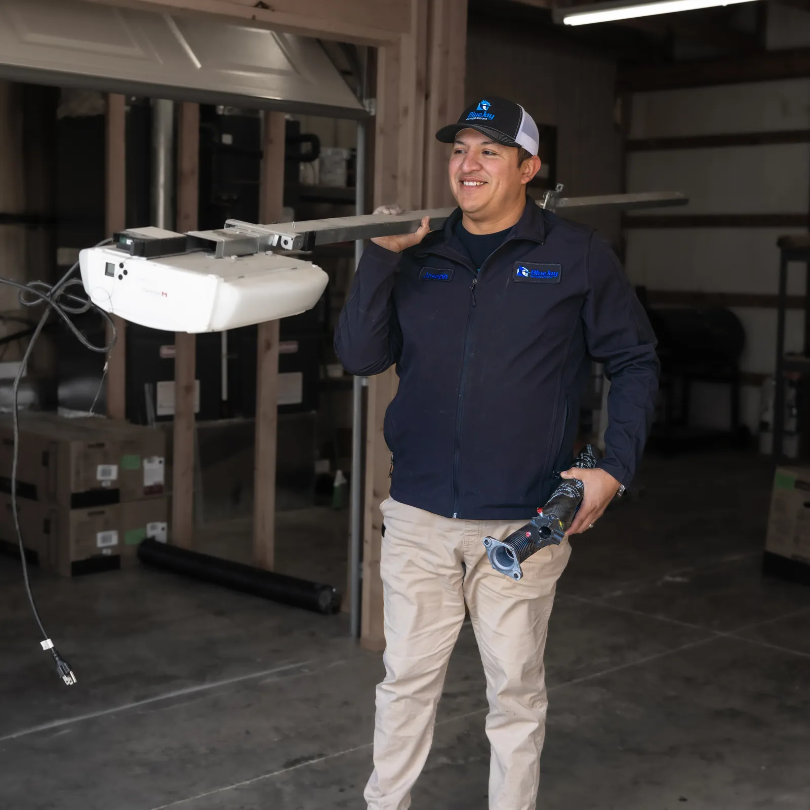 Blue Jay technician holding a garage door opener during a service visit