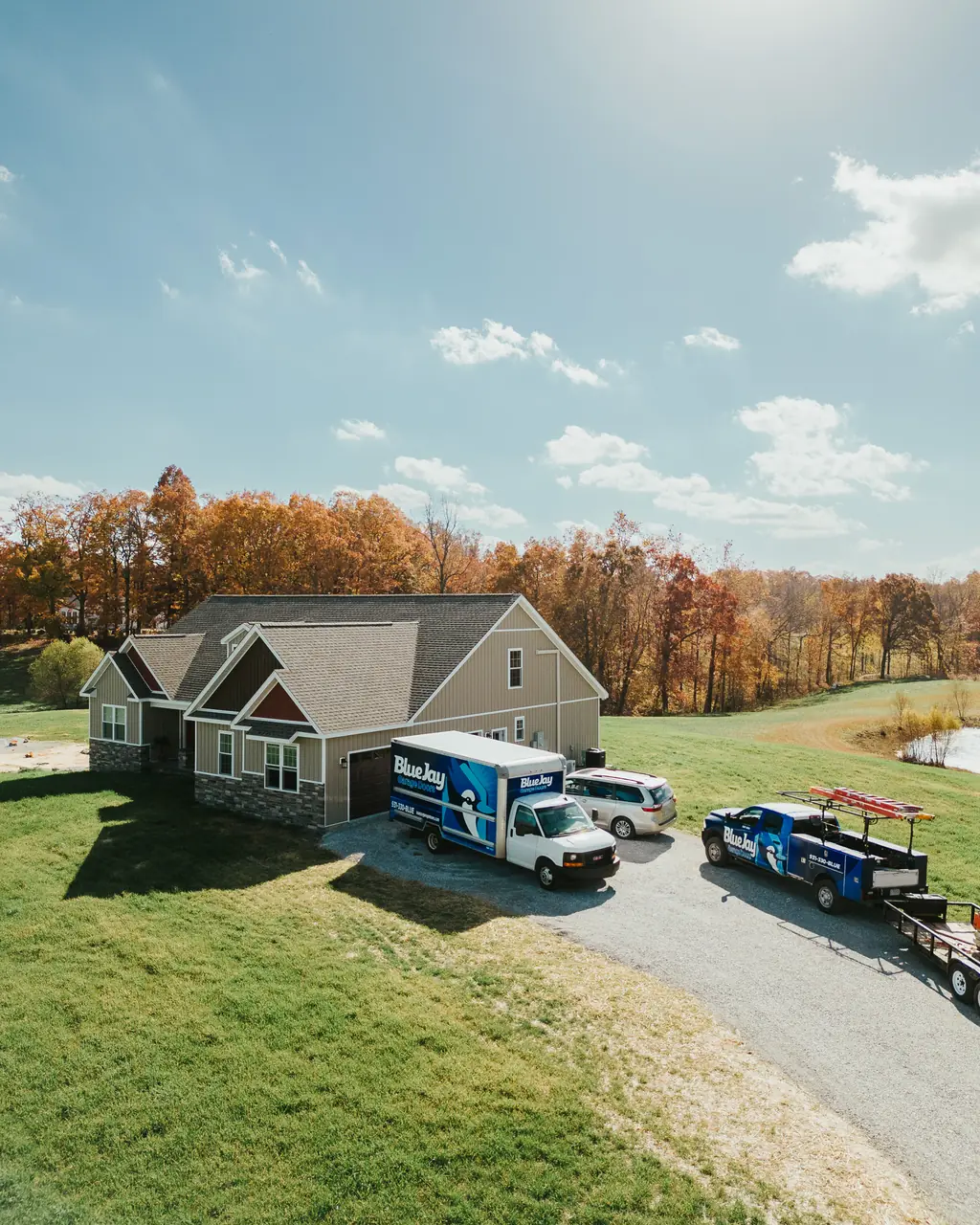 Overhead view of a home with Blue Jay service vehicles in the driveway