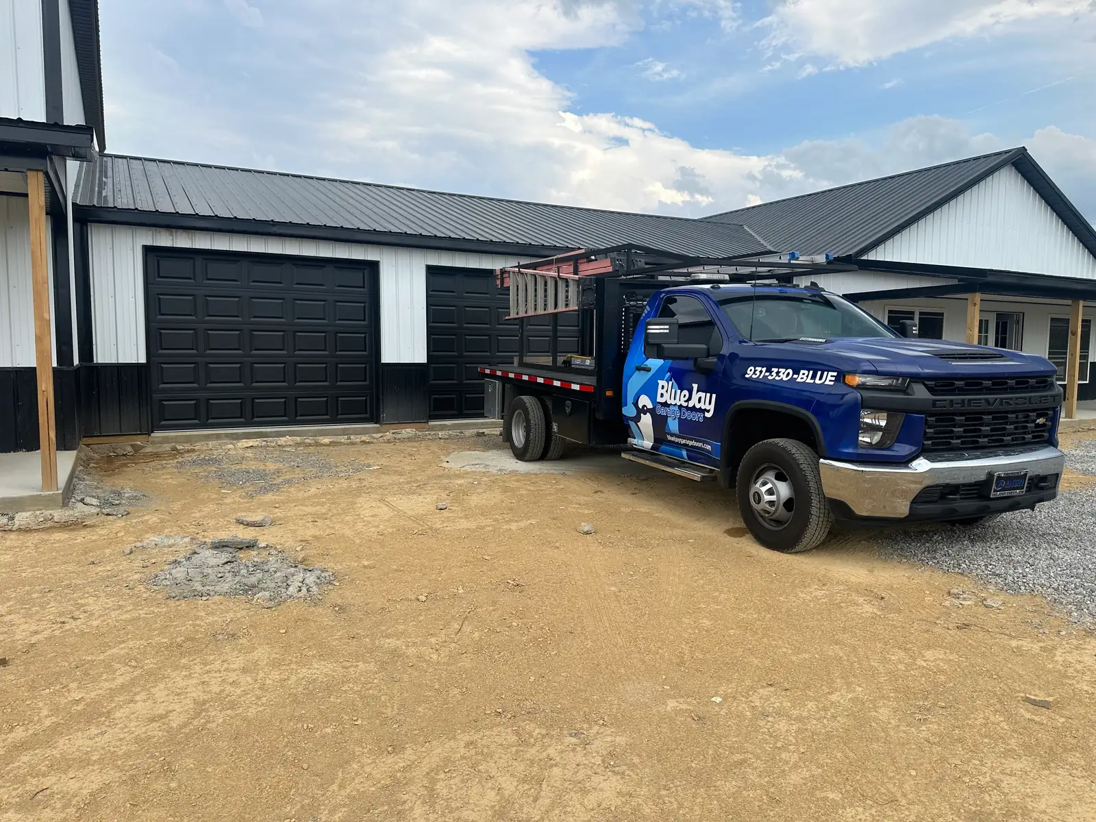 Blue Jay work truck at a garage door project