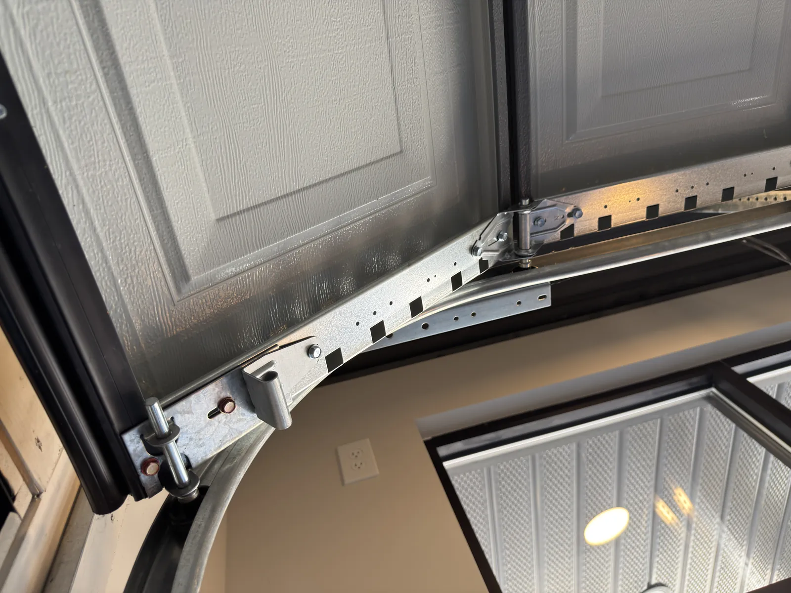 Garage door hinge, roller and curved track viewed from below
