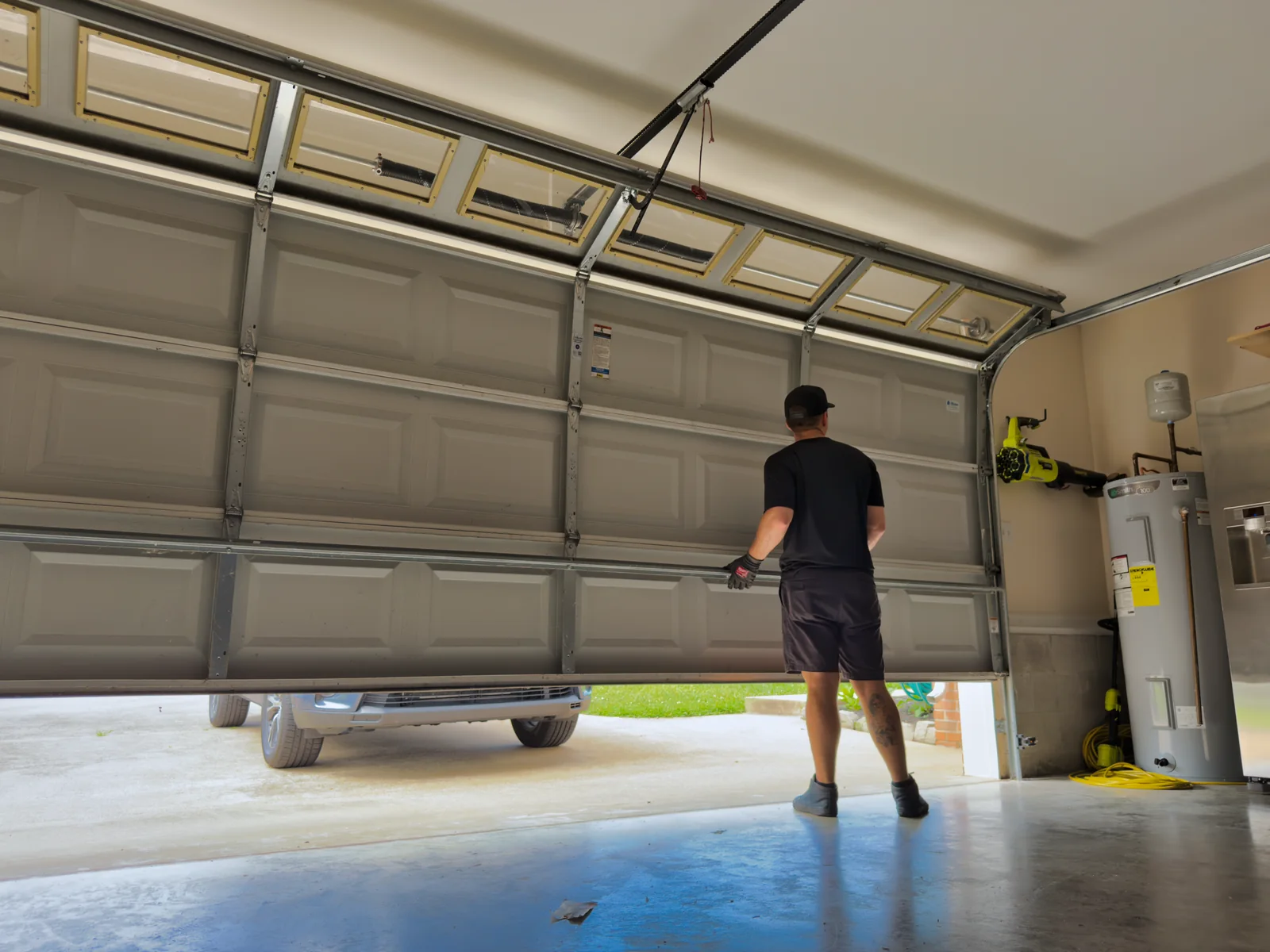 Blue Jay technician checking a garage door as it opens