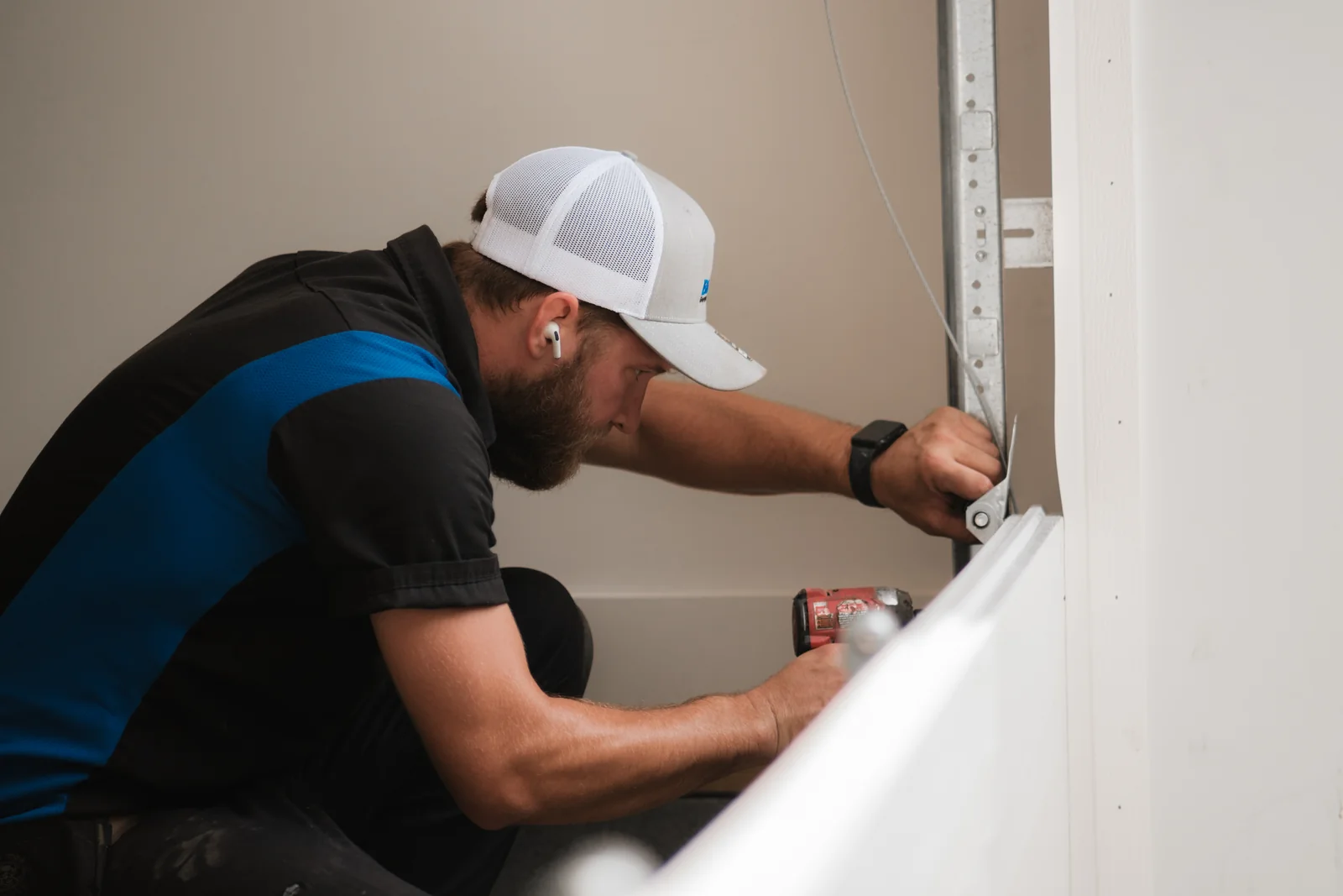 Blue Jay installer working on the track at the edge of a new garage door