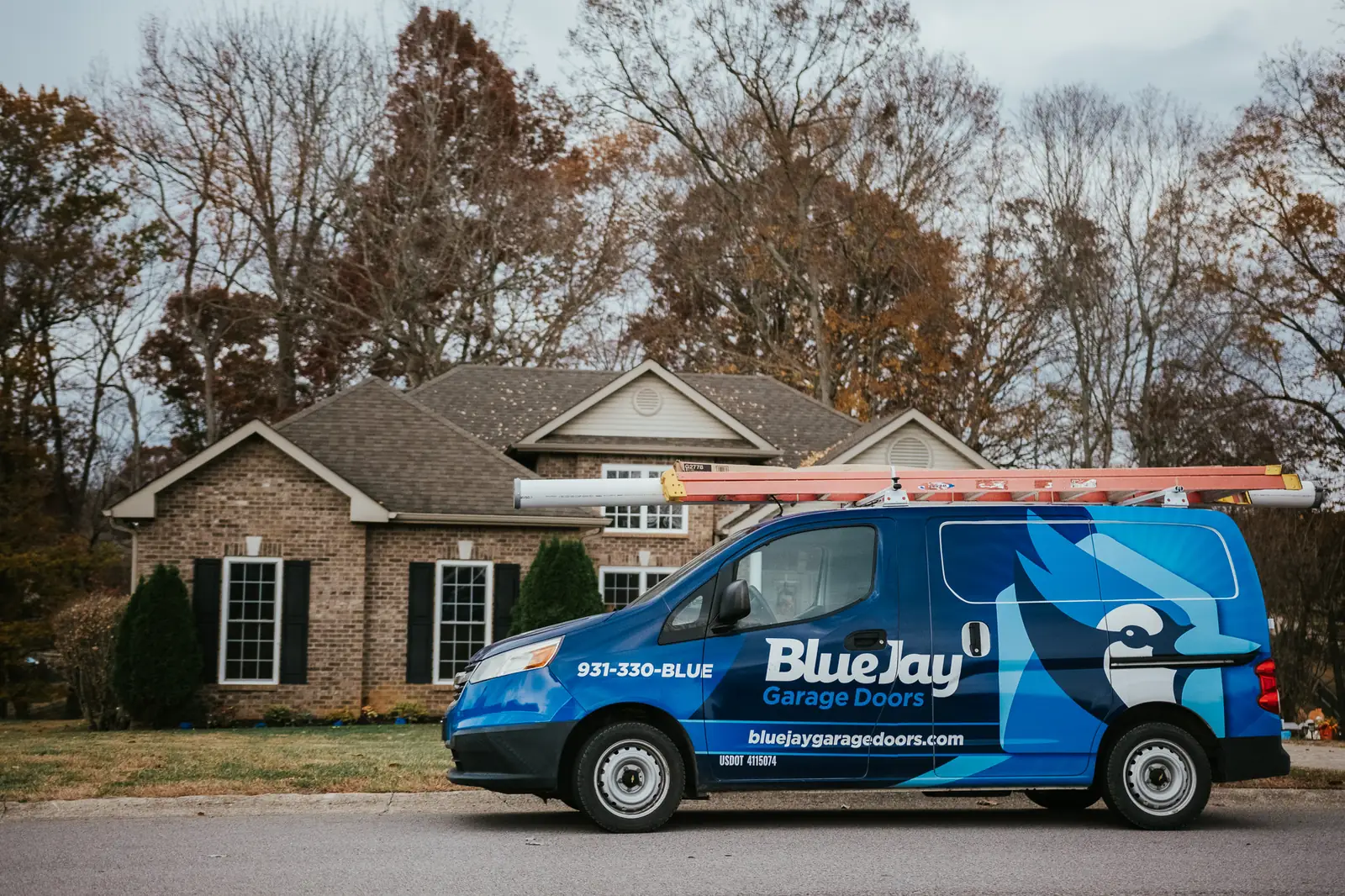 Blue Jay service van parked in front of a home