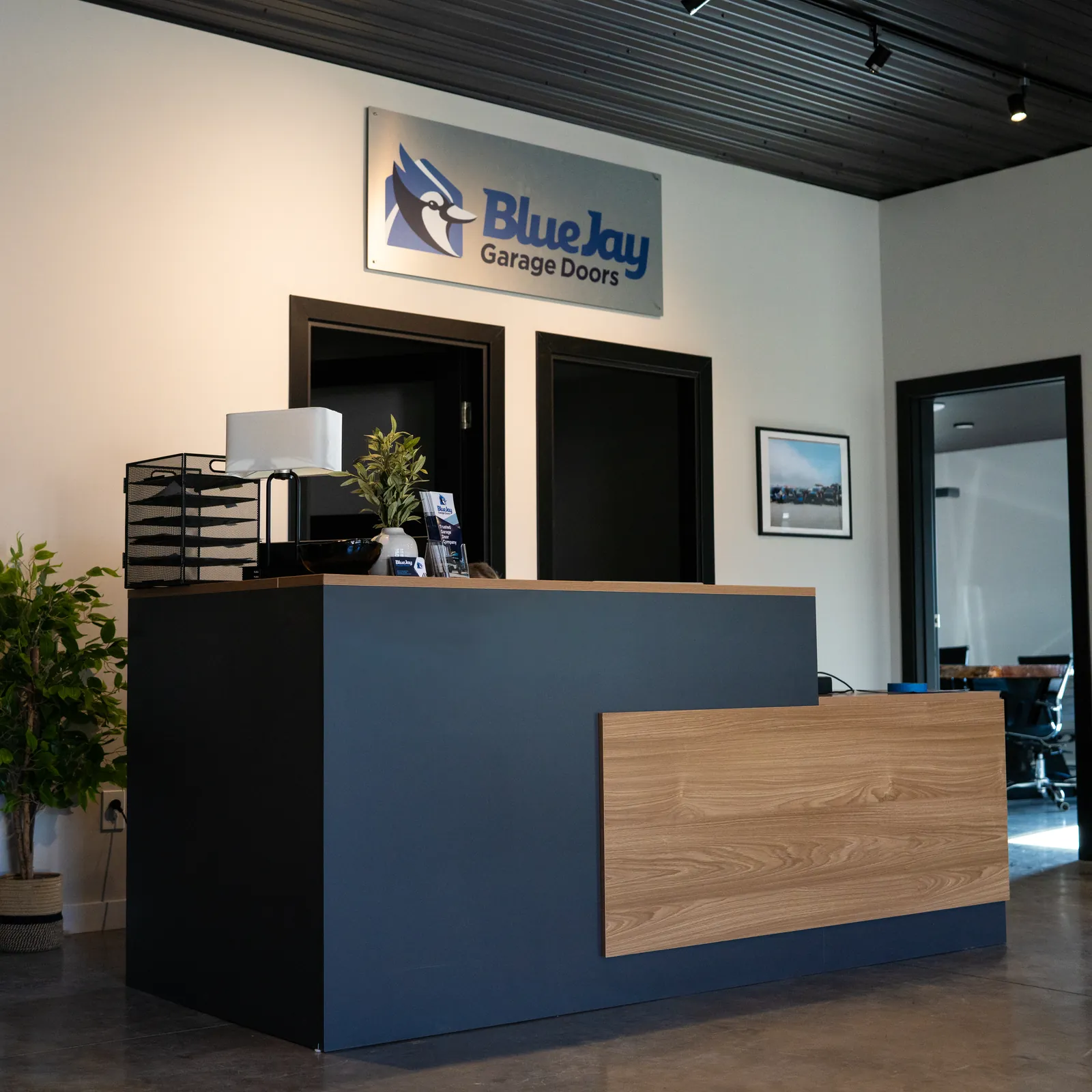 Blue Jay reception counter with the company logo on the wall