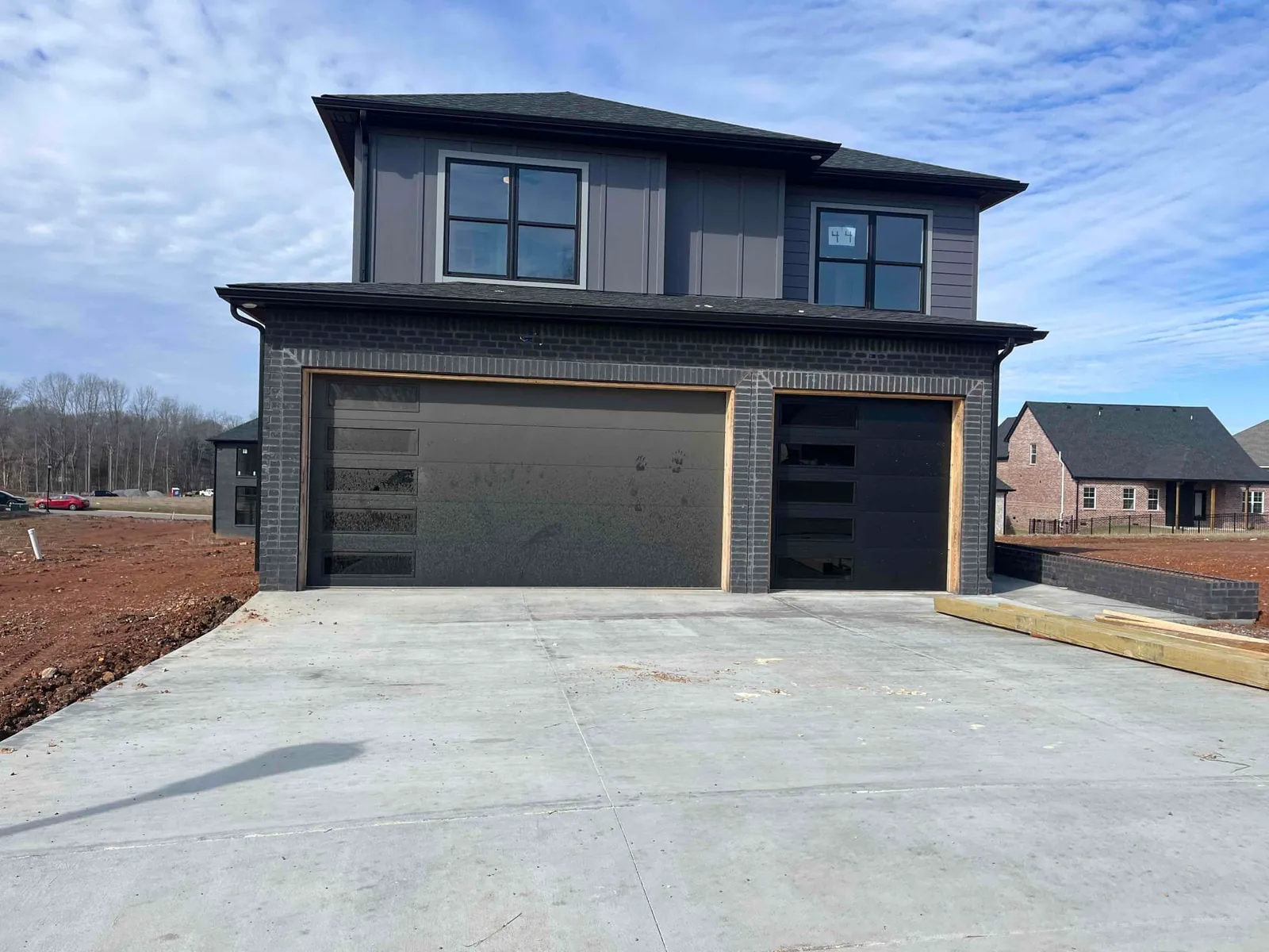 Modern dark garage doors on a two-story home