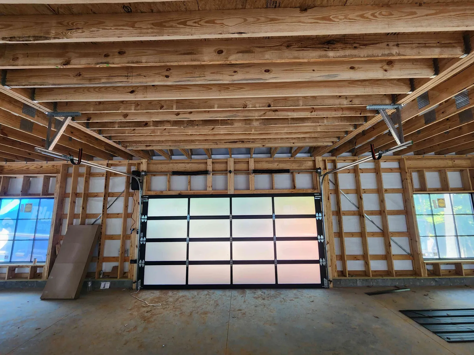 Translucent full-view garage door inside a timber-framed garage