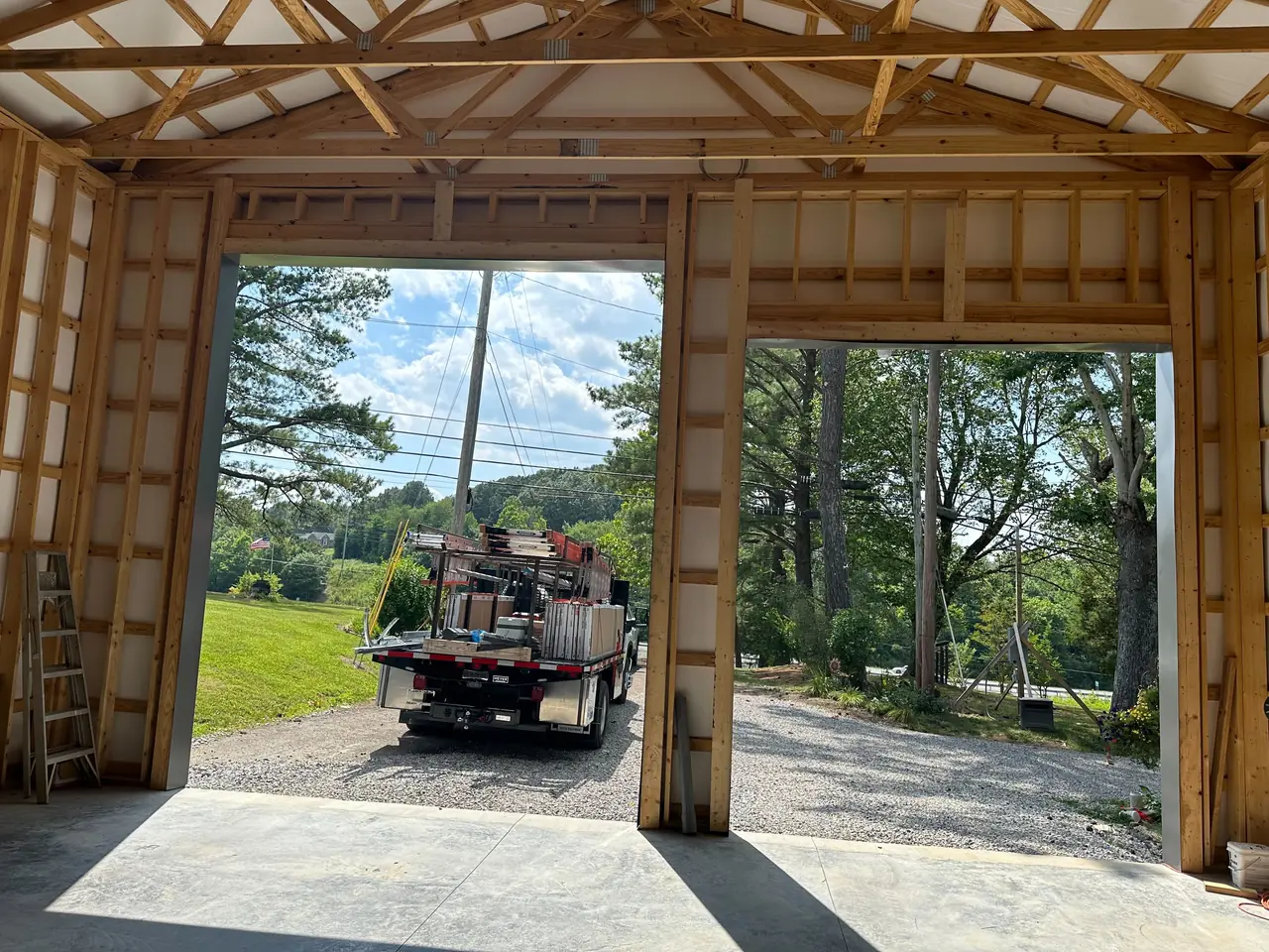 A work truck viewed through an open garage door during installation