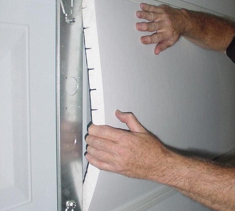 a person installing garage door insulation