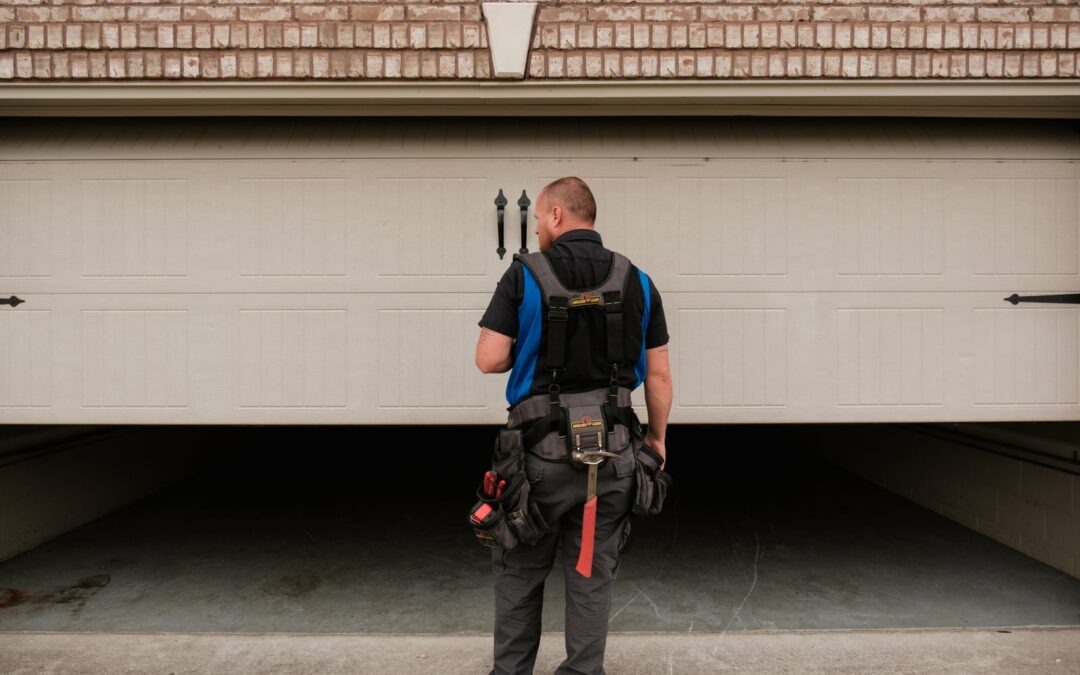 Blue Jay Garage Doors repair man inspecting garage door