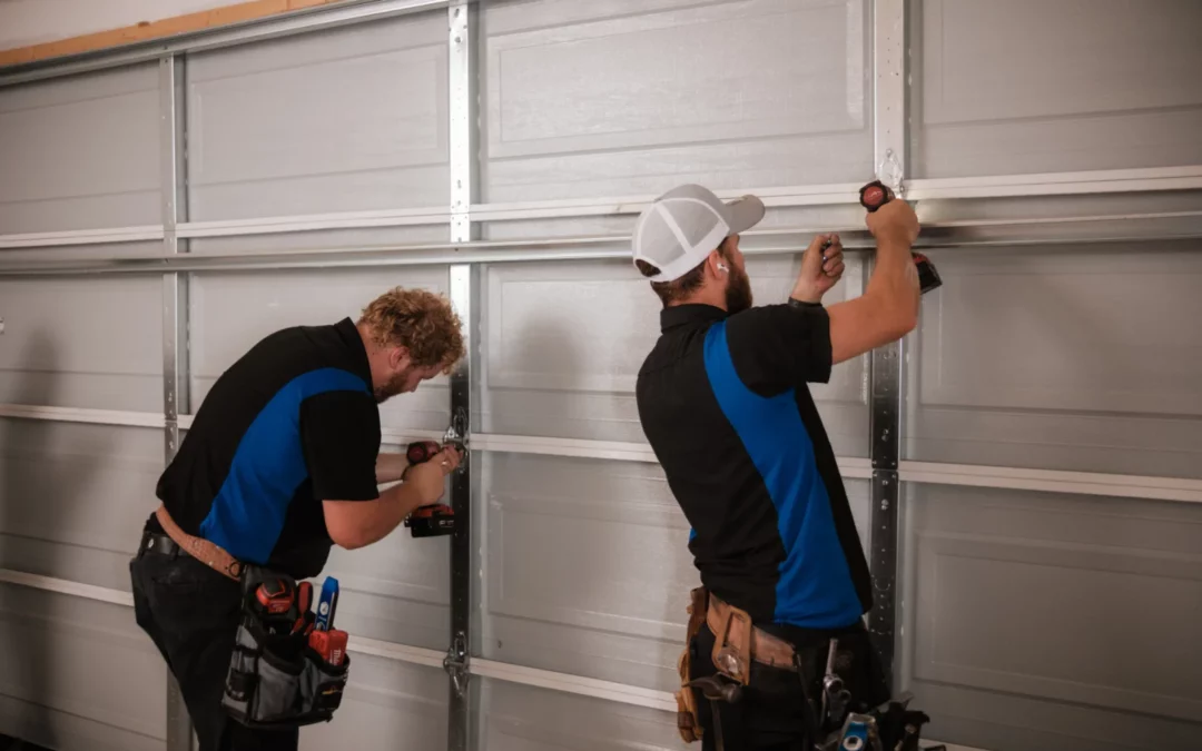 Blue Jay Garage Doors technicians adjusting hinges on Garage Door