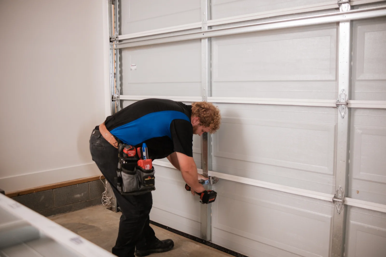 fixing hinges A Blue Jay Garage Doors technician working on a garage door