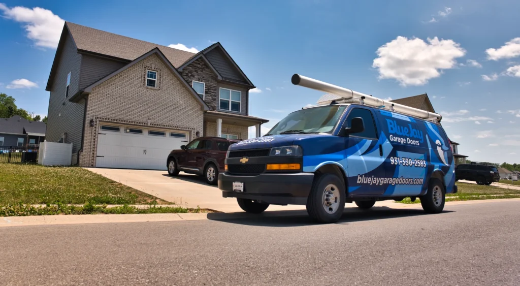 Blue Jay Garage Doors service van in front of a house