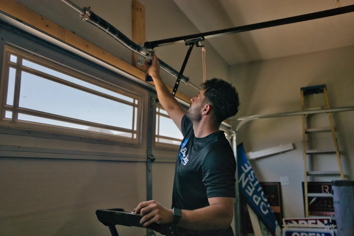 technician inspecting garage door spring