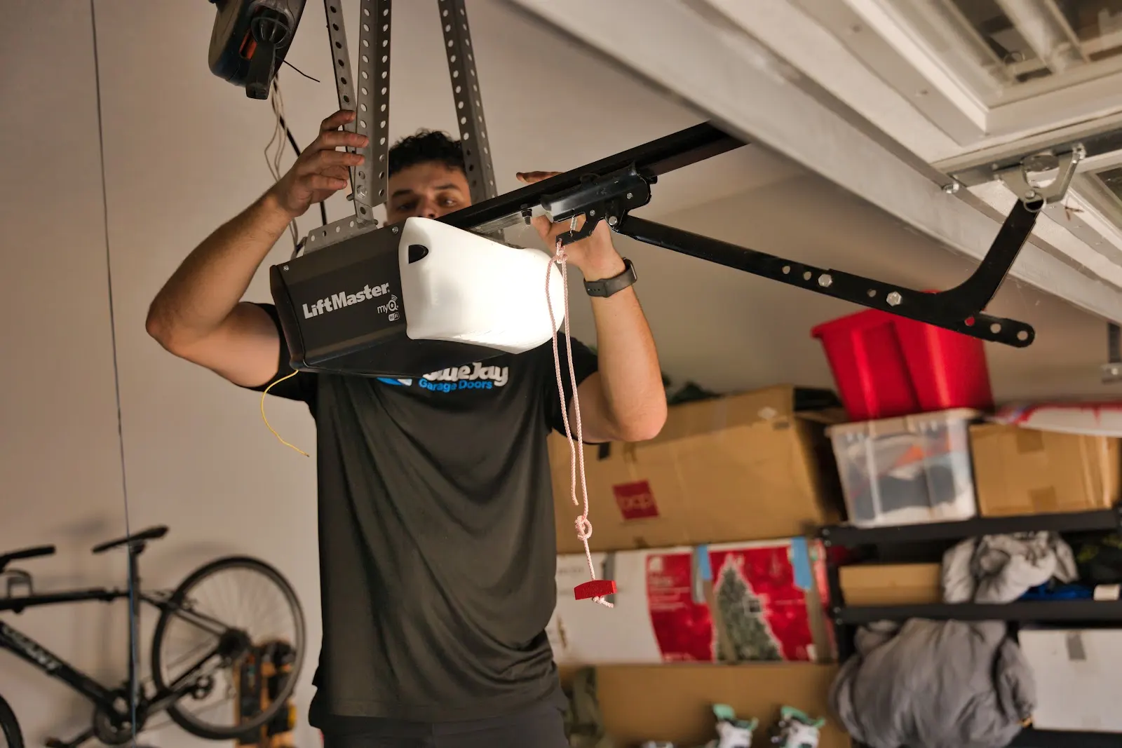 Garage Door Won't Close All the Way? 6 Causes and Which Ones You Can Fix Yourself Blue Jay technician inspecting a garage door opener